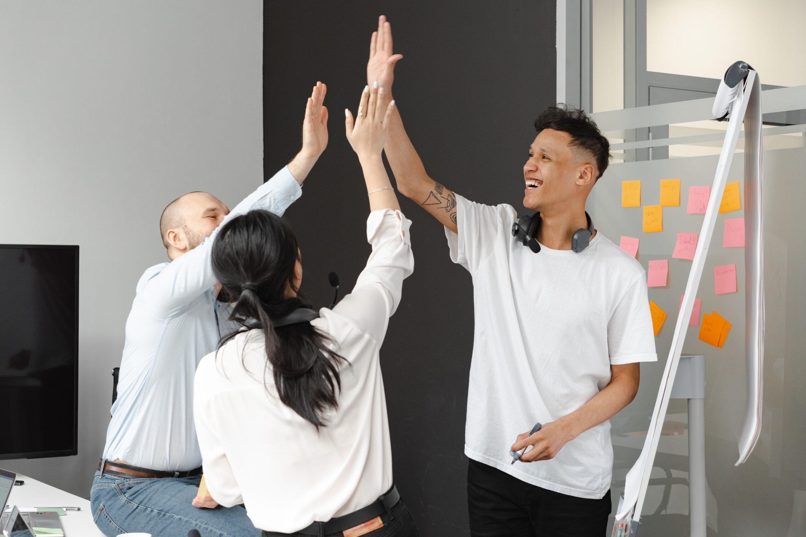 three receptionists giving eachother a high five