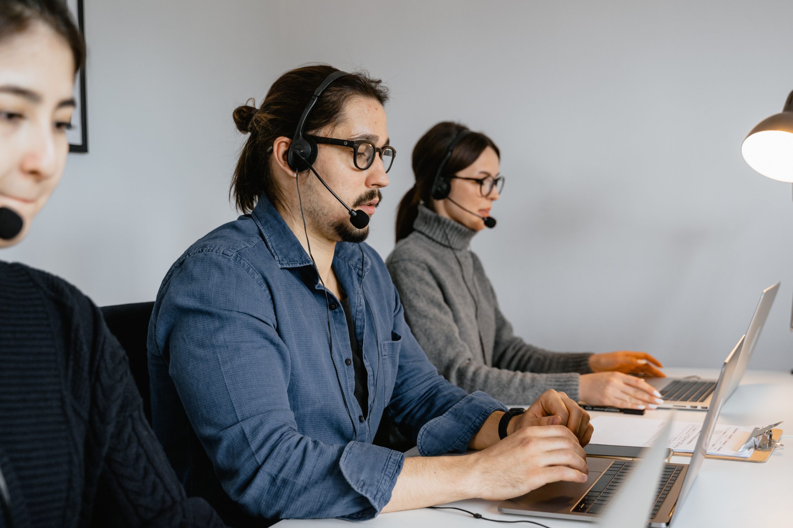 three receptionists on the phone with customers