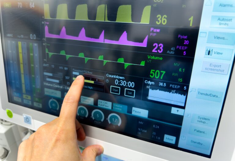 A hand traces a healthcare machine line